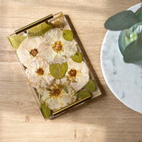 Rectangle resin serving tray with gold handles.