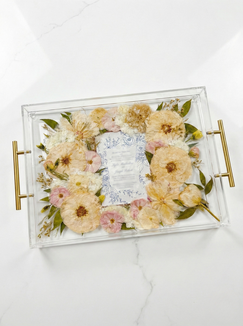 Pressed flower serving tray with an invitation and a preserved boutonniere