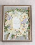 White, green, and blue florals pressed and preserved into a large wooden frame.