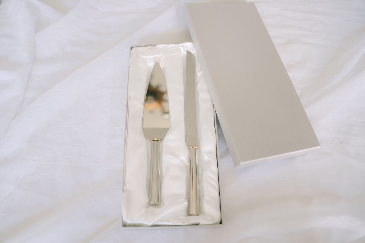 Gold ring handled wedding cake knife and server set from Element Marketplace, shown in gift box