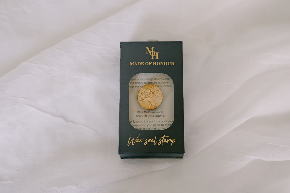 Brass wildflower wax seal stamp from Element Marketplace, shown in packaging