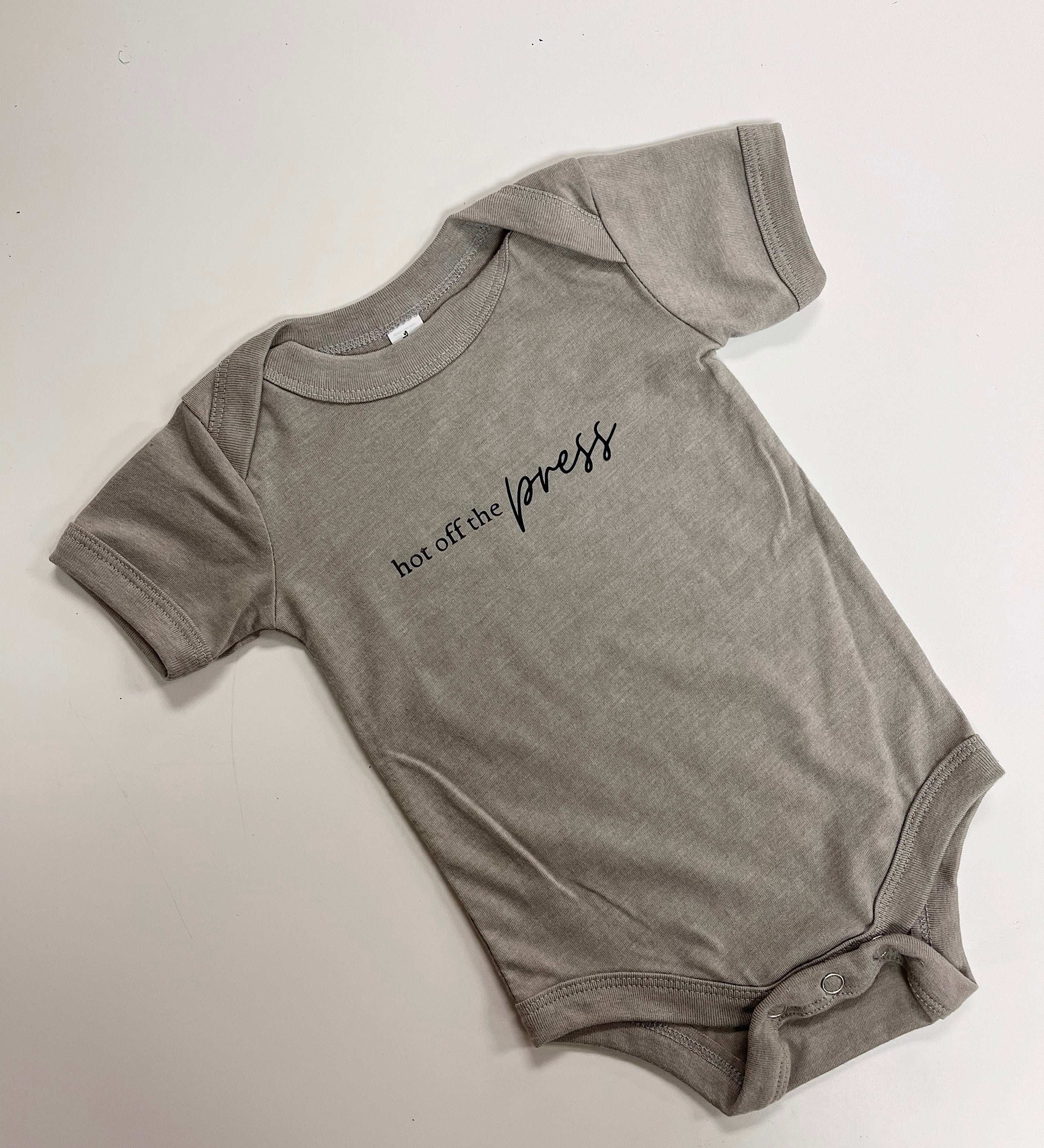 Hot off the press baby onesie in heather olive green