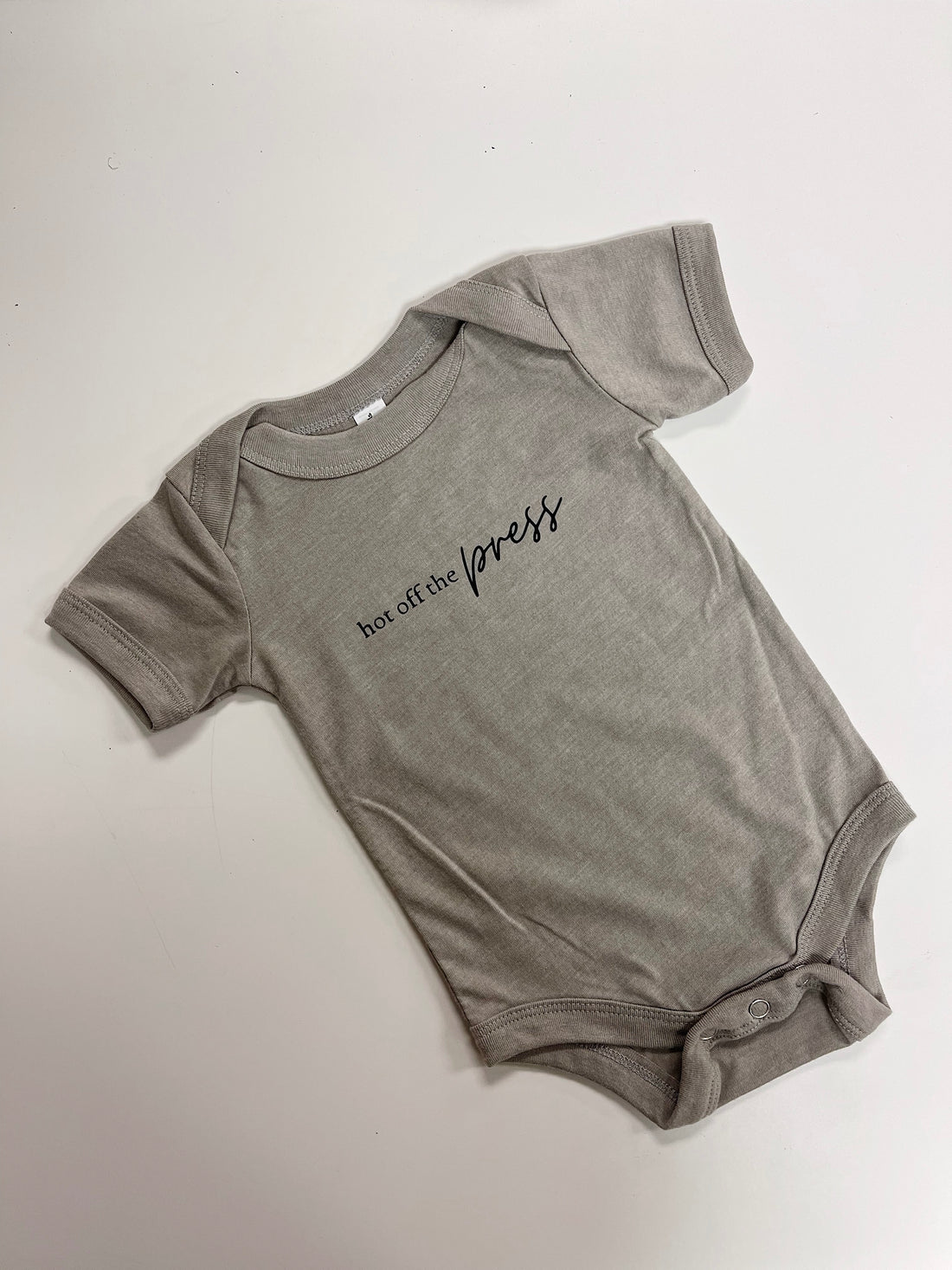 Hot off the press baby onesie in heather olive green