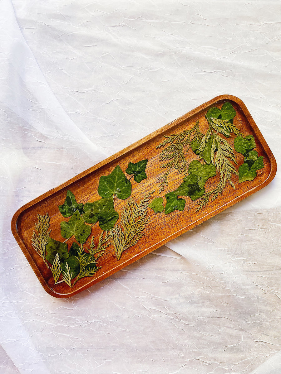 Pressed greenery on a wooden resin tray for holiday home decor