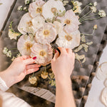 Pressed Bouquet Shop designer organizing a frame design in burst style