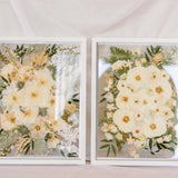 Two white wedding bouquets pressed in a 16x20" white wood frame