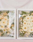 Two white wedding bouquets pressed in a 16x20" white wood frame