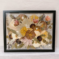 Pressed flower wedding bouquet design in a 16x20 black wood frame standing horizontally