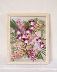 A bright and vibrant pink and green bouquet made up of orchids and roses has been pressed and framed in a natural wood bouquet preservation frame.